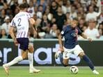Toulouse's Danish defender Rasmus Nicolaisen and Paris Saint-Germain's French forward Kylian Mbappe fight for the ball. Toulouse's Danish defender Rasmus Nicolaisen and Paris Saint-Germain's French forward Kylian Mbappe fight for the ball.