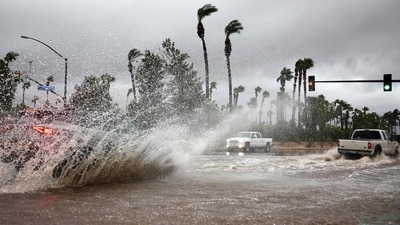 Vehicles drive through a flooded street as Tropical Storm Hilary moves through the area on August 20, 2023 in Cathedral City, California. Southern California is under a first-ever tropical storm warning as Hilary impacts parts of California, Arizona and Nevada. All California state beaches have been closed in San Diego and Orange counties in preparation for the impacts from the storm, which was downgraded from hurricane status. (Getty Images via AFP) Vehicles drive through a flooded street as Tropical Storm Hilary moves through the area on August 20, 2023 in Cathedral City, California. Southern California is under a first-ever tropical storm warning as Hilary impacts parts of California, Arizona and Nevada. All California state beaches have been closed in San Diego and Orange counties in preparation for the impacts from the storm, which was downgraded from hurricane status. (Getty Images via AFP)