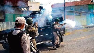 Security personnel fire tear gas shells to disperse those protesting for withdrawal of central forces, in Imphal East on August 16. (AFP photo)