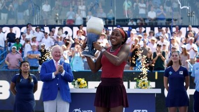 Coco Gauff, of the United States, raises the Rookwood Cup after defeating Karolina Muchova, of Czech Republic (USA TODAY Sports via Reuters Con)