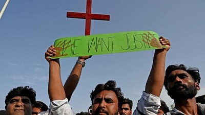 Christians hold the holy cross and a placard during a protest in Islamabad on August 20 to condemn the attacks on churches in Pakistan. (AFP) Christians hold the holy cross and a placard during a protest in Islamabad on August 20 to condemn the attacks on churches in Pakistan. (AFP)