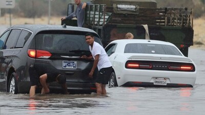 Fire officials rescued a dozen people from knee-deep water in a homeless encampment along the rising San Diego River. (AFP)