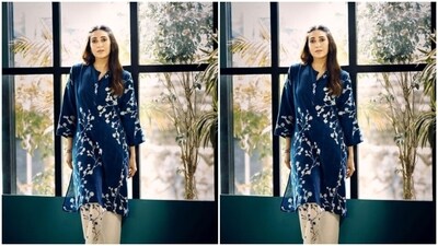Karisma looked like a dream in a dark blue kurta with quarter sleeves featuring white floral patterns throughout. She teamed it with a pair of white ethnic trousers with blue floral patterns on one leg. (Instagram/@therealkarismakapoor) Karisma looked like a dream in a dark blue kurta with quarter sleeves featuring white floral patterns throughout. She teamed it with a pair of white ethnic trousers with blue floral patterns on one leg. (Instagram/@therealkarismakapoor)