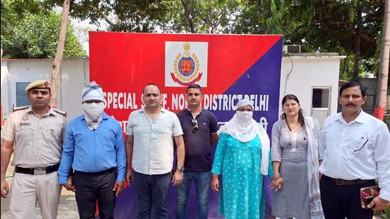 Police with the suspended rape-accused Delhi government official and his wife on Monday. (ANI)