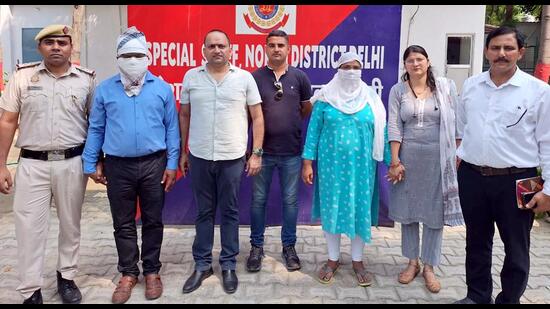 Police with the suspended rape-accused Delhi government official and his wife on Monday. (ANI)