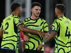 Arsenal's French defender #02 William Saliba (L), English midfielder #41 Declan Rice (C) and defender #04 Ben White celebrate