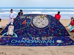 Students of Sudarsan Sand Art Institute create a sand art on ISRO's lunar mission Chandrayaan-3 at the beach in Puri