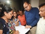 Patna district magistrate Chandrashekhar Singh looks on as enumerator canvass information from residents for a caste-based survey in Bihar in July (HT File Photo/Santosh Kumar)