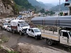 Vehicles stranded after the Kullu-Mandi national highway was blocked near Pandoh Dam on Tuesday following heavy rain overnight.