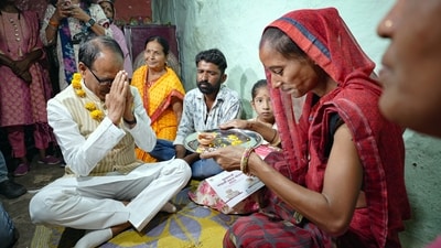 Bhopal, Jun 01 (ANI): Madhya Pradesh Chief Minister Shivraj Singh Chouhan pays respects to a woman as he goes door-to-door to distribute acceptance letters to the eligible sisters of Chief Minister's Ladli Behna Scheme, at Durga Nagar in Bhopal on Thursday. (ANI Photo) (Office of Shivraj Twitter)