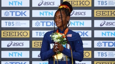 Gold medallist Sha'carri Richardson of the U.S. celebrates on the podium with her medal after winning the Women's 100m (REUTERS)