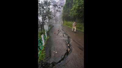 Cracks appear on a road after heavy monsoon rainfall at Kaithu, in Shimla, on Tuesday.The chief secretary informed the PMO about the current status of the restoration of the national highway at the Kainchi Mod near Pandoh which is closed for the traffic, besides the condition of other national highways. (PTI)