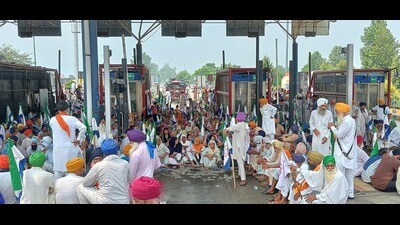 Farmers block a toll plaza in Amritsar on Tuesday. (HT photo)