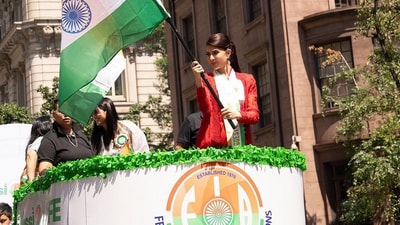 Jacqueline waves a flag atop a float. With many holding the Indian tricolour and dressed in celebratory attire, and performers dancing and playing drums, the parade served as a vibrant convergence of cultures, patriotism, and shared values that unite India and America.&nbsp;&nbsp; 