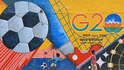 A man walks past a wall mural with India's G20 summit logo in New Delhi. (AFP)