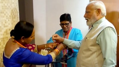 Women tie Rakhi to Prime Minister Narendra Modi, in Johannesburg, Tuesday. (PTI)