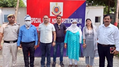 Police with the arrested Delhi government official and his wife on Monday. (ANI) Police with the arrested Delhi government official and his wife on Monday. (ANI)