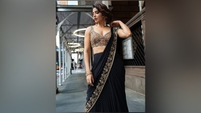 Samantha matched the saree with a heavily-embellished sleeveless blouse from Arpita Mehta's label. It features hand-embroidered gold threadwork on a black base, mirror embellishments, scalloped borders, a fitted bust, a short midriff-baring length, and a plunging neckline showing off her decolletage. (Instagram) Samantha matched the saree with a heavily-embellished sleeveless blouse from Arpita Mehta's label. It features hand-embroidered gold threadwork on a black base, mirror embellishments, scalloped borders, a fitted bust, a short midriff-baring length, and a plunging neckline showing off her decolletage. (Instagram)