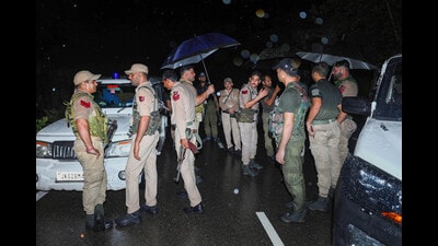 Security personnel at the Jammu-Srinagar National highway after an improvised explosive device (IED) was detected and defused, on the outskirts of Jammu. (PTI)