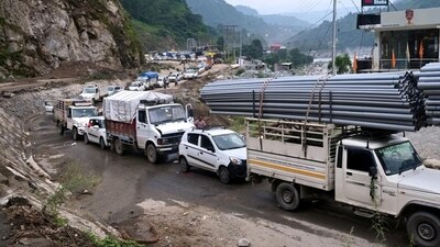Vehicles stranded after the Kullu-Mandi national highway was blocked near Pandoh Dam on Tuesday following heavy rain overnight. (HT Photo)