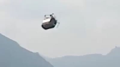 The cable car is suspended by a single rope. A minimum of 8 people are seen trapped in the car in this screengrab. (X/ Sandeep Panwar)