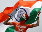 Arun Haryani, an enthusiast with his body painted in tri-colours reacts as he holds up a model of LVM3 M4 which was used in launching of Chandrayaan-3