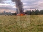A view shows smoke rising above a plane on fire following an alleged air accident at a location given as Tver region, Russia, in this still image from video published August 23, 2023.