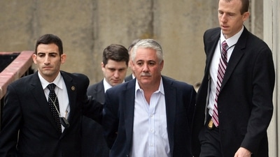 FILE — Former Suffolk County Police Chief James Burke, second from right, is escorted to a vehicle by FBI personnel outside an FBI office, in Melville, N.Y., Dec. 9, 2015. Burke, 58, who served federal prison time for beating a suspect, was arrested Tuesday, Aug. 22, 2023, for allegedly soliciting sex and exposing himself at a public park in Farmingdale, on New York's Long Island. (Steve Pfost/Newsday via AP, File) (AP) FILE — Former Suffolk County Police Chief James Burke, second from right, is escorted to a vehicle by FBI personnel outside an FBI office, in Melville, N.Y., Dec. 9, 2015. Burke, 58, who served federal prison time for beating a suspect, was arrested Tuesday, Aug. 22, 2023, for allegedly soliciting sex and exposing himself at a public park in Farmingdale, on New York's Long Island. (Steve Pfost/Newsday via AP, File) (AP)