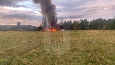 A view shows smoke rising above a plane on fire following an alleged air accident at a location given as Tver region, Russia, in this still image from video published August 23, 2023. (via REUTERS)