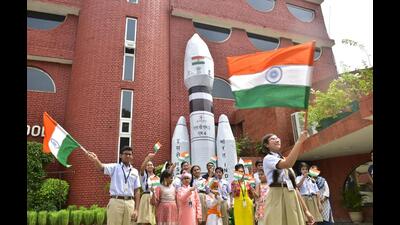 School students waving the Tricolour in Amritsar as they gathered to mark the landing of Chandrayaan-3, India’s third lunar mission, on Wednesday. The state government later announced the closure of all schools till August 26 due to heavy rain forecast. (Sameer Sehgal/HT)