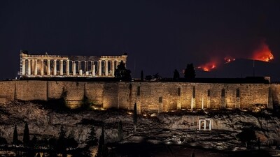 A forest burns behind the Parthenon ancient temple on top of the Acropolis hill as wildfire rages on the outskirts of Athens on August 22. (AFP) A forest burns behind the Parthenon ancient temple on top of the Acropolis hill as wildfire rages on the outskirts of Athens on August 22. (AFP)