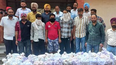 The three accused (faces covered) with the heroin consignment recovered by the anti-drug special task force (STF) personnel of Punjab Police in Amritsar district on Wednesday. (Sameer Sehgal/HT) The three accused (faces covered) with the heroin consignment recovered by the anti-drug special task force (STF) personnel of Punjab Police in Amritsar district on Wednesday. (Sameer Sehgal/HT)