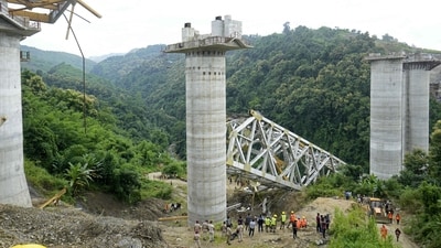 Rescue workers conduct a search operation at the site of an accident where an under-construction railway bridge collapsed in Sairang town of the Aizwal. (AFP) Rescue workers conduct a search operation at the site of an accident where an under-construction railway bridge collapsed in Sairang town of the Aizwal. (AFP)