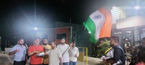 People outside ISRO headquarters in Bengaluru waving the tricolour to celebrate India's victory. (Singh Rahul SunilKumar/HT Photo)