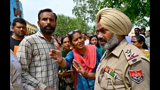 Heart rendering scenes were witnessed when 10 to 15 teachers present in the reception area of the school were seen wailing and consoling her husband Mandeep Singh. (HT Photo)
