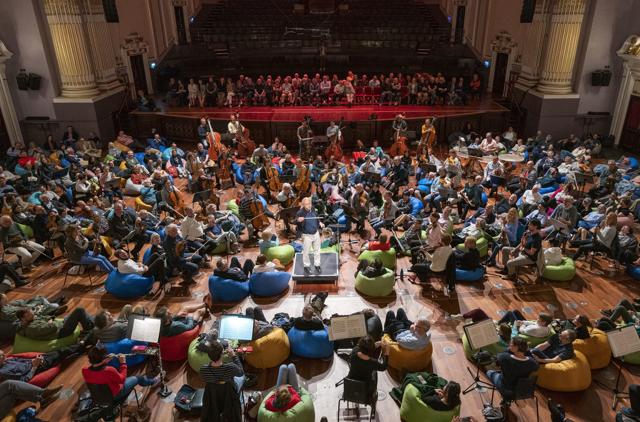 The Budapest Festival Orchestra, conducted by Ivan Fischer, perform Dvorak's Symphony No 8 in the Usher Hall at the Edinburgh International Festival, in Edinburgh on August 8, 2023. Audience members were invited to sit on bean bags amongst the musicians as the concert was one of a number of new ways of presenting classical music at the festival this year. (Jane Barlow/PA via AP) The Budapest Festival Orchestra, conducted by Ivan Fischer, perform Dvorak's Symphony No 8 in the Usher Hall at the Edinburgh International Festival, in Edinburgh on August 8, 2023. Audience members were invited to sit on bean bags amongst the musicians as the concert was one of a number of new ways of presenting classical music at the festival this year. (Jane Barlow/PA via AP)
