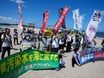 People protest at a beach toward the Fukushima Daiichi nuclear power plant.