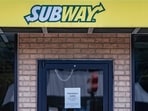 A temporarily closed sign hangs on the door of a Subway outlet. A temporarily closed sign hangs on the door of a Subway outlet.