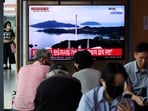 Passengers watch a TV broadcasting a news report on North Korea firing a space rocket, at a railway station in Seoul, South Korea, August 24, 2023. 