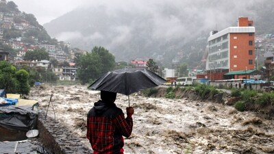 A man looks at a swollen Beas River following heavy rains in Kullu, Himachal Pradesh. (AP)