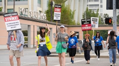 Picketers carry signs outside Fox studios on Monday, Aug. 14, 2023, in Los Angeles. The Hollywood writers strike passed the 100-day mark as the film and television industries remain paralyzed by dual actors and screenwriters strikes. (AP Photo/Chris Pizzello) (Chris Pizzello/Invision/AP) Picketers carry signs outside Fox studios on Monday, Aug. 14, 2023, in Los Angeles. The Hollywood writers strike passed the 100-day mark as the film and television industries remain paralyzed by dual actors and screenwriters strikes. (AP Photo/Chris Pizzello) (Chris Pizzello/Invision/AP)