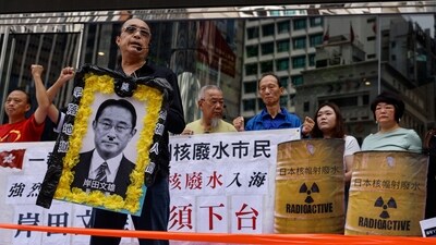 A demonstrator holds an image of Prime Minister of Japan, Fumio Kishida during a protest after Japan's announcement to release treated radioactive water from the crippled Fukushima nuclear plant into the sea, in Hong Kong, China, August 24, 2023. (REUTERS)