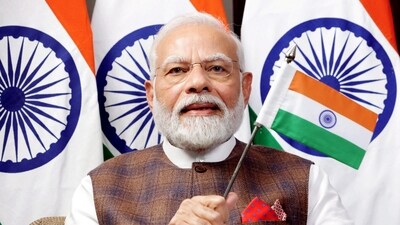 Prime Minister Narendra Modi waves the Indian flag while watching the telecast of Chandrayaan-3's successful soft landing on the Moon (PTI) Prime Minister Narendra Modi waves the Indian flag while watching the telecast of Chandrayaan-3's successful soft landing on the Moon (PTI)