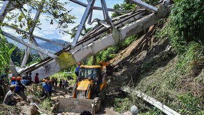 Rescue workers conduct a search operation at the site of an accident where an under-construction railway bridge collapsed in Sairang town of the Aizwal district in Mizoram. (AFP)