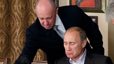 Yevgeny Prigozhin, top, serves food to then-Russian Prime Minister Vladimir Putin at Prigozhin's restaurant outside Moscow, Russia, on Nov. 11, 2011. (AP Photo/File) Yevgeny Prigozhin, top, serves food to then-Russian Prime Minister Vladimir Putin at Prigozhin's restaurant outside Moscow, Russia, on Nov. 11, 2011. (AP Photo/File)