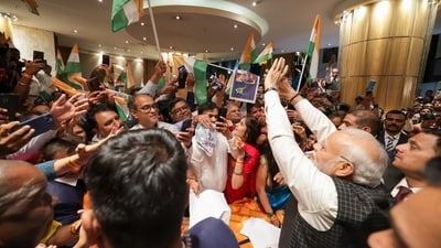 Several members of the Indian diaspora can be seen gathered, holding the tricolour and Chandrayaan placards. Several members of the Indian diaspora can be seen gathered, holding the tricolour and Chandrayaan placards.