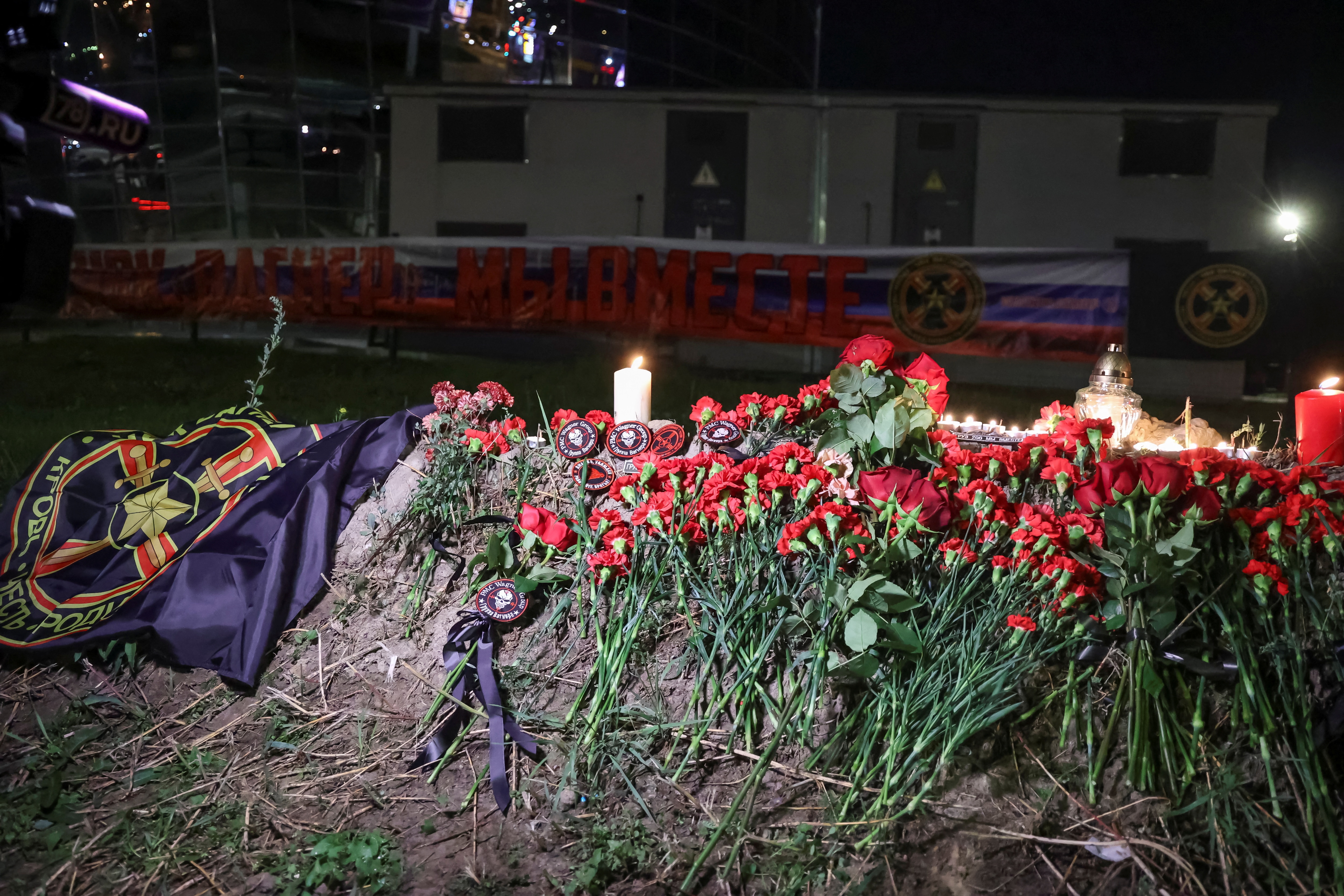 People put flowers and patches at a makeshift memorial near former PMC Wagner Centre in Saint Petersburg, Russia August 24, 2023.  (REUTERS)
