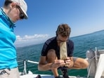 Pascal Hagmann, founder and director of NGO Oceaneye, and Laurianne Trimoulla, head of communication, look at the samples of weeds and plastic fragments that were collected in the water of Lake Leman in Founex, near Geneva, Switzerland August 21.(REUTERS)