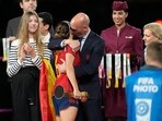 President of Spain's soccer federation, Luis Rubiales, right, hugs Spain's Aitana Bonmati on the podium following Spain's win in the final of Women's World Cup soccer against England at Stadium Australia in Sydney, Australia, Sunday, Aug. 20, 2023. At left is Spain's Princess Infanta Sofia. President of Spain's soccer federation, Luis Rubiales, right, hugs Spain's Aitana Bonmati on the podium following Spain's win in the final of Women's World Cup soccer against England at Stadium Australia in Sydney, Australia, Sunday, Aug. 20, 2023. At left is Spain's Princess Infanta Sofia.