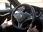 Autopilot features are demonstrated in a Tesla Model S.